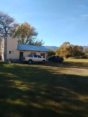 a white truck parked in front of a house at Cabañas Misky Wayra in San Francisco del Monte de Oro