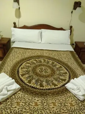 a bedroom with a bed with a rug on it at Cabañas Misky Wayra in San Francisco del Monte de Oro