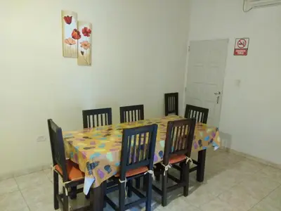 a dining room table with chairs and a colorful table cloth at Cabañas Misky Wayra in San Francisco del Monte de Oro