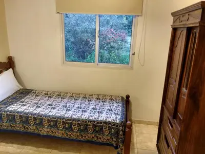 a bedroom with a bed and a window at Cabañas Misky Wayra in San Francisco del Monte de Oro