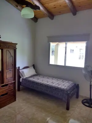 a bedroom with a bed and a window at Cabañas Misky Wayra in San Francisco del Monte de Oro
