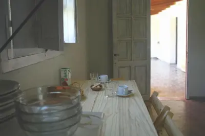 a wooden table with cups and glasses on top of it at al otro lado del río in San Francisco del Monte de Oro