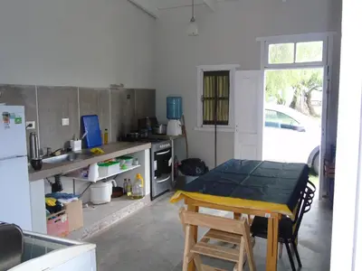 a kitchen with a table and a dining room table at al otro lado del río in San Francisco del Monte de Oro