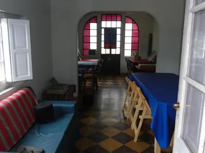 a room with a table and chairs and windows at al otro lado del río in San Francisco del Monte de Oro