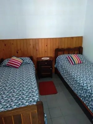 two beds sitting next to each other in a room at Departamentos Calamuchita in Santa Rosa de Calamuchita