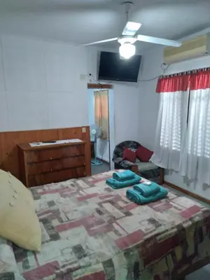 a bedroom with a large bed in a room at Departamentos Calamuchita in Santa Rosa de Calamuchita