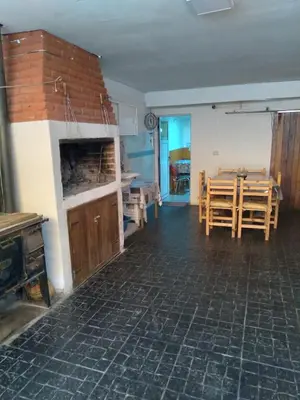 a living room with a table and a dining room at Departamentos Calamuchita in Santa Rosa de Calamuchita