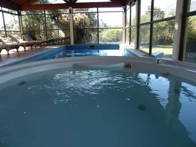 a large pool with a hot tub in a house at Altos del Sol - Spa & Resort in Merlo