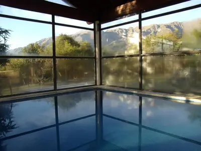 a swimming pool with a view of the mountains at Altos del Sol - Spa & Resort in Merlo