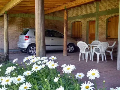 a car parked next to a table and chairs at Dalmacia Petit Hotel in Nono