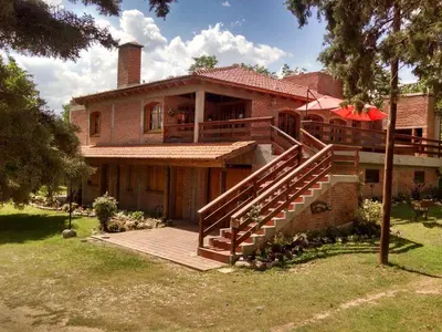 a house with a staircase in front of it at Dalmacia Petit Hotel in Nono