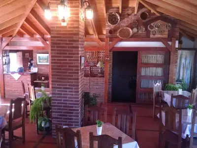 a dining room with tables and chairs and a brick wall at Dalmacia Petit Hotel in Nono