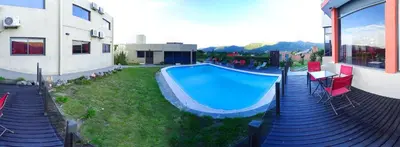 a swimming pool in a yard next to a building at Complejo Riro Namaste in San Antonio de Arredondo