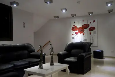 a living room with two leather chairs and a table at Complejo Riro Namaste in San Antonio de Arredondo