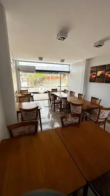 a dining room with tables and chairs and a large window at Complejo Riro Namaste in San Antonio de Arredondo