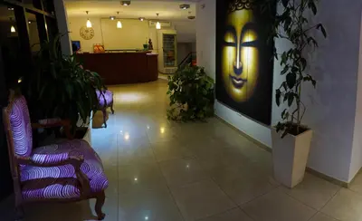a lobby with purple chairs and a face on the wall at Complejo Riro Namaste in San Antonio de Arredondo