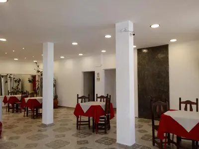 a dining room with tables and chairs with red table cloth at Hotel Bialet Massé in Bialet Massé
