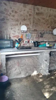 a counter in a room with a stone wall at Cabañas La Rústica in Bialet Massé