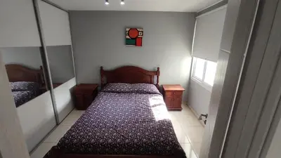 a small bedroom with a bed and a mirror at Apartamento Allegro in Cordoba