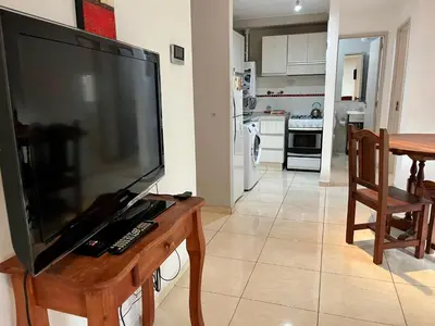 a large flat screen tv sitting on top of a wooden table at Apartamento Allegro in Cordoba