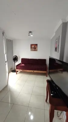 a living room with a red couch in a room at Apartamento Allegro in Cordoba