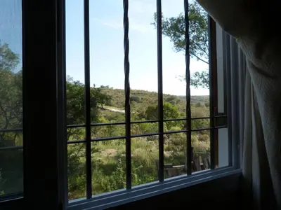 a window with a view of a field at El Pinar - Hospedaje Serrano in Tanti