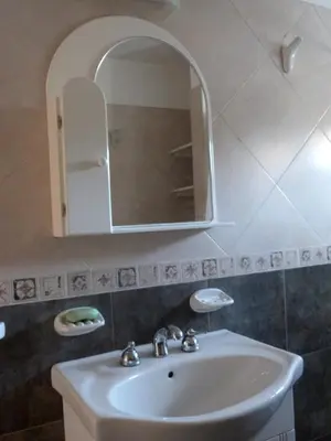 a bathroom with a sink and a mirror at El Pinar - Hospedaje Serrano in Tanti