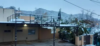 a balcony on top of a building in the snow at LA FOGLIA departamentos in Villa Carlos Paz