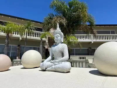 a statue of a woman sitting in a meditation pose at Villa La Font Apart Hotel & Spa in Villa Carlos Paz