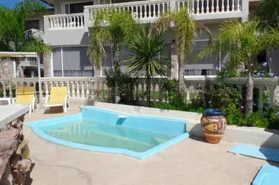 a pool in the middle of a patio at Villa La Font Apart Hotel & Spa in Villa Carlos Paz