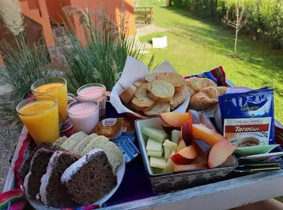 a picnic table with a tray of food and drinks at Punta Piedra cabañas & suites in Los Reartes