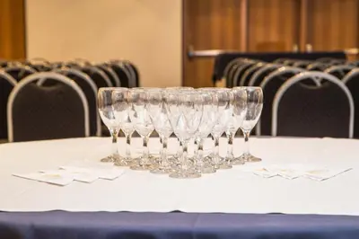 three wine glasses sitting on top of a table at King David Flat Hotel - Argentina in Cordoba