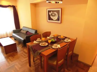 a living room with a dining table and a couch at King David Flat Hotel - Argentina in Cordoba