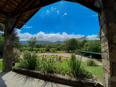 a view of a garden through a window at Posada Alma del Arroyo & Spa in Villa General Belgrano