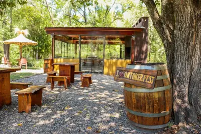 a wooden barrel sitting next to a tree at Posada Alma del Arroyo & Spa in Villa General Belgrano