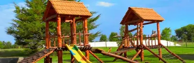 a playground with a slide and two towers at Cabañas Juan Salvador in Los Reartes