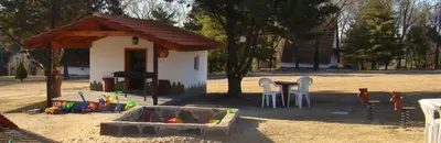 a childs play area with a sandbox and a table and chairs at Cabañas Juan Salvador in Los Reartes