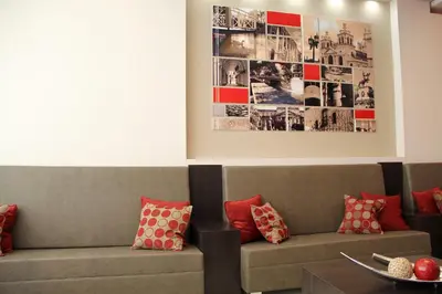 a living room with a couch and a picture on the wall at Sol de Piedra Apart, Suites & Spa in Cordoba