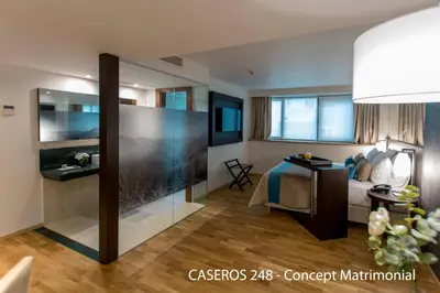 a hotel room with a bed and a glass wall at Caseros 248 Hotel in Cordoba