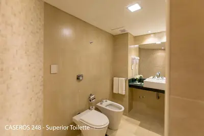 a bathroom with a toilet and a sink at Caseros 248 Hotel in Cordoba