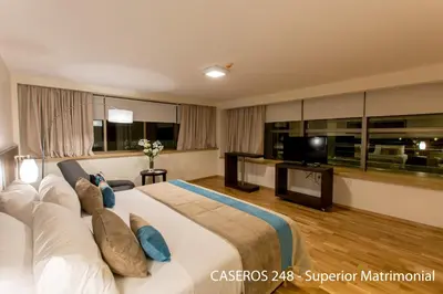 a hotel room with a large bed and a television at Caseros 248 Hotel in Cordoba