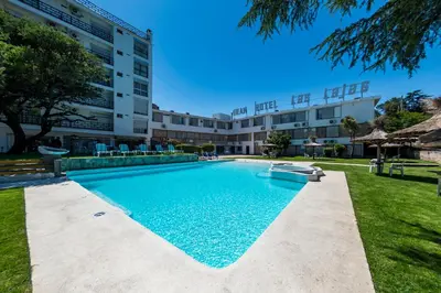 a swimming pool in front of a building at Gran Hotel Las Lajas in Villa Carlos Paz
