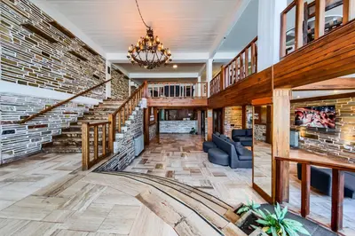 a large living room with a brick wall at Gran Hotel Las Lajas in Villa Carlos Paz