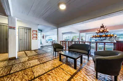 a living room with chairs and a table at Gran Hotel Las Lajas in Villa Carlos Paz