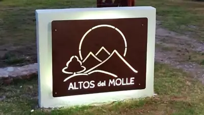 a sign for an alitzos ad mobile at ALTOS DEL MOLLE en VCP predio con solo 2 cabañas in Villa Carlos Paz