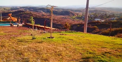 a green hill with a view of a mountain at ALTOS DEL MOLLE en VCP predio con solo 2 cabañas in Villa Carlos Paz