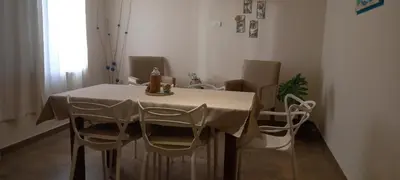 a dining room table with white chairs and a white table cloth at ALTOS DEL MOLLE en VCP predio con solo 2 cabañas in Villa Carlos Paz