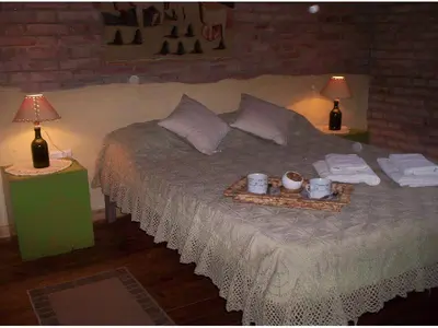 a bedroom with a large bed with two lamps on it at Cabanas Las Achiras in San Javier