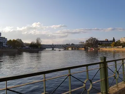 a view of a river with a bridge in the background at Departamento Loft VCP in Villa Carlos Paz