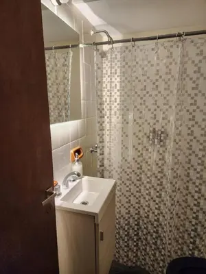 a bathroom with a sink and a shower at Departamento Loft VCP in Villa Carlos Paz